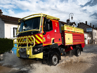 A fire truck drives over a flooded street in Coulommiers, Seine-et-Marne department, east of Paris, on October 10, 2024, as the heavy rains...