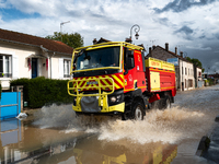 A fire truck drives over a flooded street in Coulommiers, Seine-et-Marne department, east of Paris, on October 10, 2024, as the heavy rains...