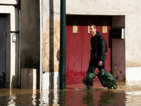 A man walks down a flooded street in Coulommiers, Seine-et-Marne department, east of Paris, on October 10, 2024, as the heavy rains associat...