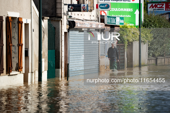 A man walks down a flooded street in Coulommiers, Seine-et-Marne department, east of Paris, on October 10, 2024, as the heavy rains associat...