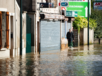 A man walks down a flooded street in Coulommiers, Seine-et-Marne department, east of Paris, on October 10, 2024, as the heavy rains associat...