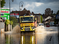 A fire truck drives over a flooded street in Coulommiers, Seine-et-Marne department, east of Paris, on October 10, 2024, as the heavy rains...