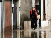 A man walks down a flooded street in Coulommiers, Seine-et-Marne department, east of Paris, on October 10, 2024, as the heavy rains associat...