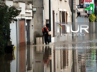 A man walks down a flooded street in Coulommiers, Seine-et-Marne department, east of Paris, on October 10, 2024, as the heavy rains associat...