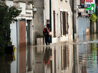 A man walks down a flooded street in Coulommiers, Seine-et-Marne department, east of Paris, on October 10, 2024, as the heavy rains associat...