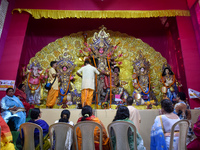 Devotees worship an idol of the Hindu goddess Durga inside a temporary platform called a pandal during the Hindu religious festival Durga Pu...