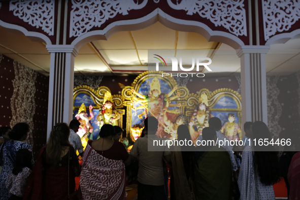 Hindu devotees visit a puja mandap during the Durga Puja festival in Dhaka, Bangladesh, on October 10, 2024. 