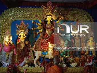 A priest worships an idol of the Hindu goddess Durga inside a temporary platform called a pandal during the Hindu religious festival Durga P...