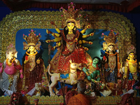 A priest worships an idol of the Hindu goddess Durga inside a temporary platform called a pandal during the Hindu religious festival Durga P...