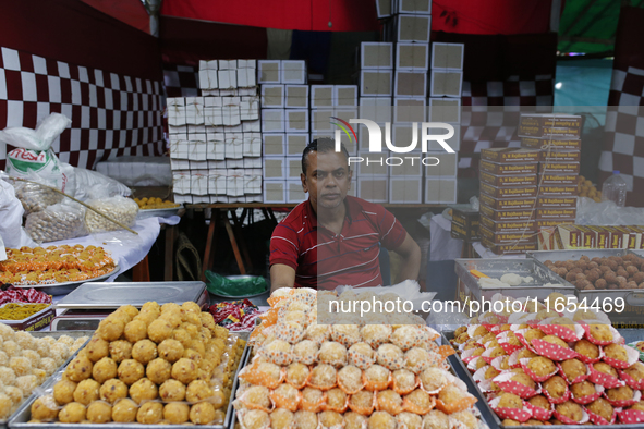 A vendor sells sweets outside a temple during the Durga Puja festival in Dhaka, Bangladesh, on October 10, 2024. 