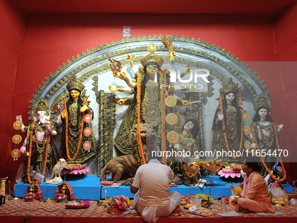 Devotees worship an idol of the Hindu goddess Durga inside a temporary platform called a pandal during the Hindu religious festival Durga Pu...