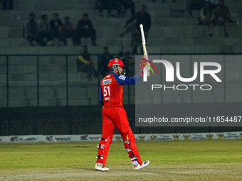 Ben Dunk of India Capitals raises his bat after scoring 50 during the Legends League Cricket T20 match between Manipal Tigers and India Capi...