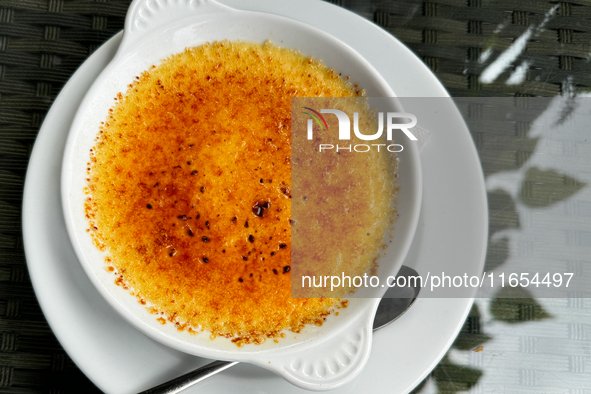 A creme brulee dessert is seen at a restaurant table in this illustration photo taken in Krakow, Poland on October 10, 2024. 