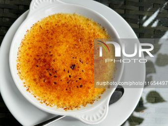 A creme brulee dessert is seen at a restaurant table in this illustration photo taken in Krakow, Poland on October 10, 2024. (