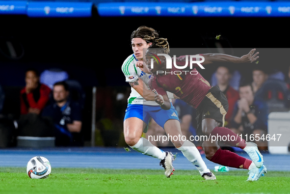 Riccardo Calafiori of Italy and Jeremy Doku of Belgium compete for the ball during the UEFA Nations League 2024/25 League A Group A2 match b...