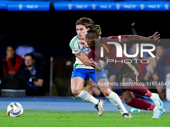 Riccardo Calafiori of Italy and Jeremy Doku of Belgium compete for the ball during the UEFA Nations League 2024/25 League A Group A2 match b...