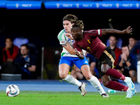 Riccardo Calafiori of Italy and Jeremy Doku of Belgium compete for the ball during the UEFA Nations League 2024/25 League A Group A2 match b...