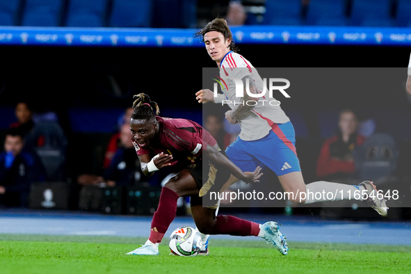 Riccardo Calafiori of Italy and Jeremy Doku of Belgium compete for the ball during the UEFA Nations League 2024/25 League A Group A2 match b...