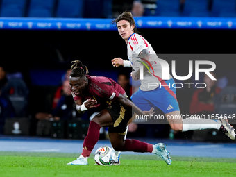 Riccardo Calafiori of Italy and Jeremy Doku of Belgium compete for the ball during the UEFA Nations League 2024/25 League A Group A2 match b...