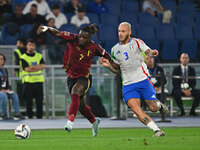 Jeremy Doku (BEL) and Federico Dimarco (ITA) are in action during the UEFA National League Matchday 3 match between Italy and Belgium at the...