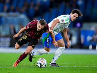 Leonardo Trossard of Belgium and Samuele Ricci of Italy compete for the ball during the UEFA Nations League 2024/25 League A Group A2 match...