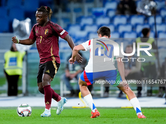 Jeremy Doku of Belgium and Andrea Cambiaso of Italy compete for the ball during the UEFA Nations League 2024/25 League A Group A2 match betw...