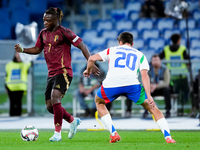 Jeremy Doku of Belgium and Andrea Cambiaso of Italy compete for the ball during the UEFA Nations League 2024/25 League A Group A2 match betw...