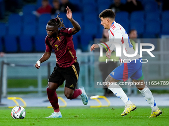 Jeremy Doku of Belgium and Giovanni Di Lorenzo of Italy compete for the ball during the UEFA Nations League 2024/25 League A Group A2 match...