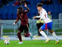 Jeremy Doku of Belgium and Giovanni Di Lorenzo of Italy compete for the ball during the UEFA Nations League 2024/25 League A Group A2 match...