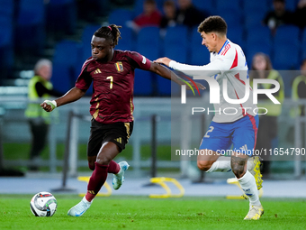 Jeremy Doku of Belgium and Giovanni Di Lorenzo of Italy compete for the ball during the UEFA Nations League 2024/25 League A Group A2 match...