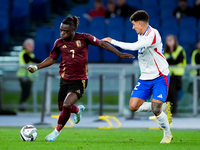 Jeremy Doku of Belgium and Giovanni Di Lorenzo of Italy compete for the ball during the UEFA Nations League 2024/25 League A Group A2 match...