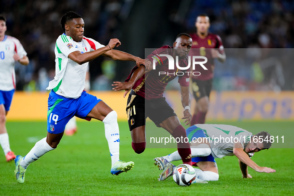 Dodi Lukebakio of Belgium and Destiny Udogie of Italy compete for the ball during the UEFA Nations League 2024/25 League A Group A2 match be...