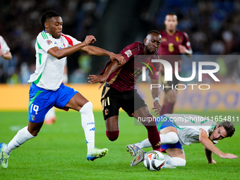 Dodi Lukebakio of Belgium and Destiny Udogie of Italy compete for the ball during the UEFA Nations League 2024/25 League A Group A2 match be...