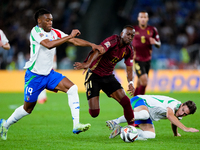 Dodi Lukebakio of Belgium and Destiny Udogie of Italy compete for the ball during the UEFA Nations League 2024/25 League A Group A2 match be...