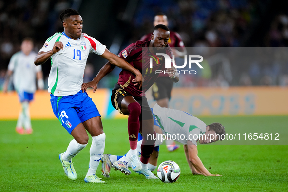 Dodi Lukebakio of Belgium and Destiny Udogie of Italy compete for the ball during the UEFA Nations League 2024/25 League A Group A2 match be...