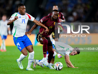 Dodi Lukebakio of Belgium and Destiny Udogie of Italy compete for the ball during the UEFA Nations League 2024/25 League A Group A2 match be...