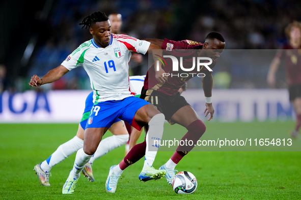 Dodi Lukebakio of Belgium and Destiny Udogie of Italy compete for the ball during the UEFA Nations League 2024/25 League A Group A2 match be...