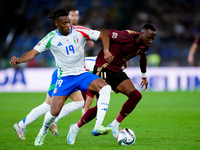 Dodi Lukebakio of Belgium and Destiny Udogie of Italy compete for the ball during the UEFA Nations League 2024/25 League A Group A2 match be...