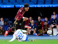 Malick Fofana of Belgium and Giovanni Di Lorenzo of Italy compete for the ball during the UEFA Nations League 2024/25 League A Group A2 matc...