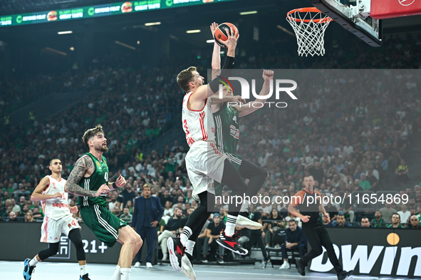 Andreas Obst of FC Bayern Munich competes with Marius Grigonis of Panathinaikos AKTOR Athens during the Euroleague, Round 2 match between Pa...