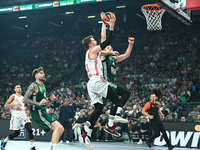 Andreas Obst of FC Bayern Munich competes with Marius Grigonis of Panathinaikos AKTOR Athens during the Euroleague, Round 2 match between Pa...