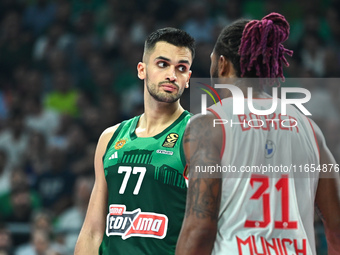 Omer Yurtseven of Panathinaikos AKTOR Athens and Devin Booker of FC Bayern Munich participate in the Euroleague, Round 2 match between Panat...