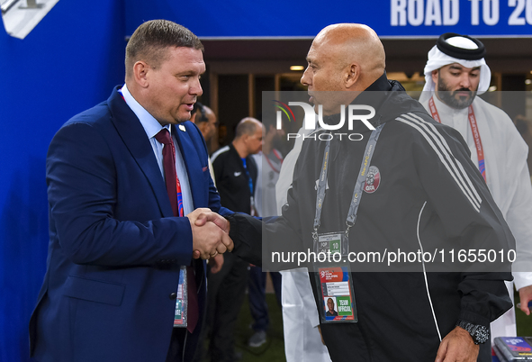 Qatar National team head coach Bartolome Marquez and Kyrgyzstan National team head coach Maksim Lisitsyn shake hands prior to kick-off ahead...