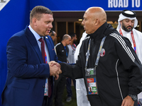 Qatar National team head coach Bartolome Marquez and Kyrgyzstan National team head coach Maksim Lisitsyn shake hands prior to kick-off ahead...