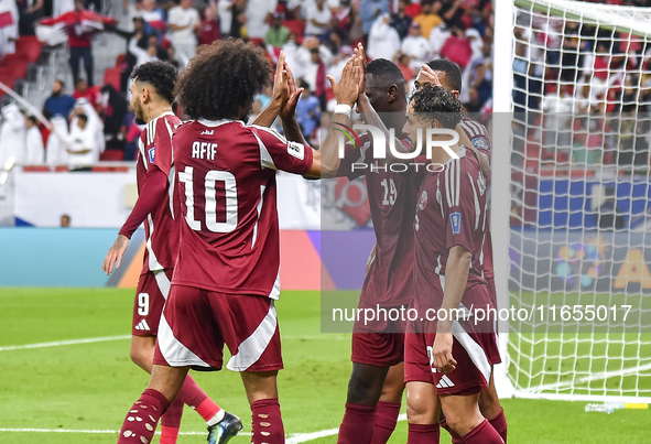 Almoez Ali (C) of Qatar celebrates with teammates after scoring the opening goal during the FIFA World Cup 2026 AFC Asian Qualifiers 3rd rou...