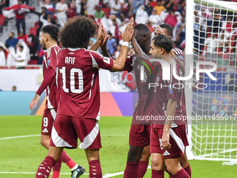 Almoez Ali (C) of Qatar celebrates with teammates after scoring the opening goal during the FIFA World Cup 2026 AFC Asian Qualifiers 3rd rou...