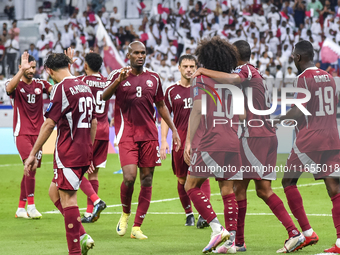 Almoez Ali (R) of Qatar celebrates with teammates after scoring the opening goal during the FIFA World Cup 2026 AFC Asian Qualifiers 3rd rou...