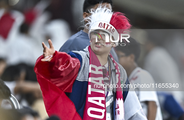 A fan from Qatar cheers for their team before the FIFA World Cup 2026 AFC Asian Qualifiers 3rd round group A match between Qatar and Kyrgyzs...