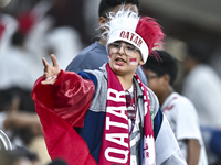 A fan from Qatar cheers for their team before the FIFA World Cup 2026 AFC Asian Qualifiers 3rd round group A match between Qatar and Kyrgyzs...