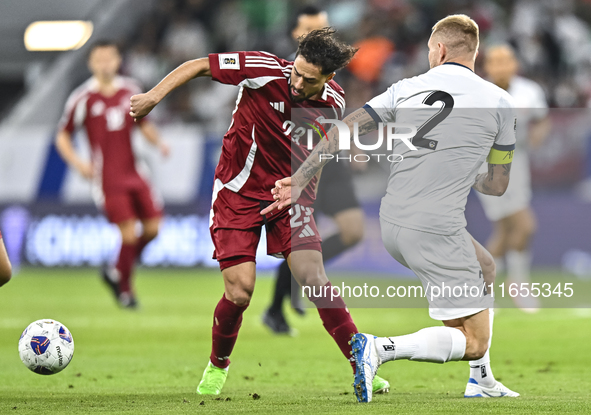 Abdelrahman Fahmi Moustafa (L) of Qatar battles for the ball with Kichin Valerii (R) of Kyrgyzstan during the FIFA World Cup 2026 AFC Asian...